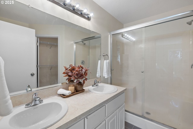 17848 SW Eldred Ln, Sherwood, OR 97140 - bathroom featuring a stall shower, double vanity, and a spacious closet