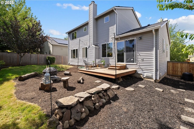 17848 SW Eldred Ln, Sherwood, OR 97140 - back of property featuring a wooden deck, a fenced backyard, and a chimney