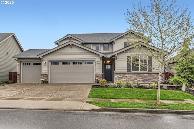 4747 S 17th Dr, Ridgefield, WA 98642 - craftsman house featuring a garage, a front yard, driveway, and stone siding