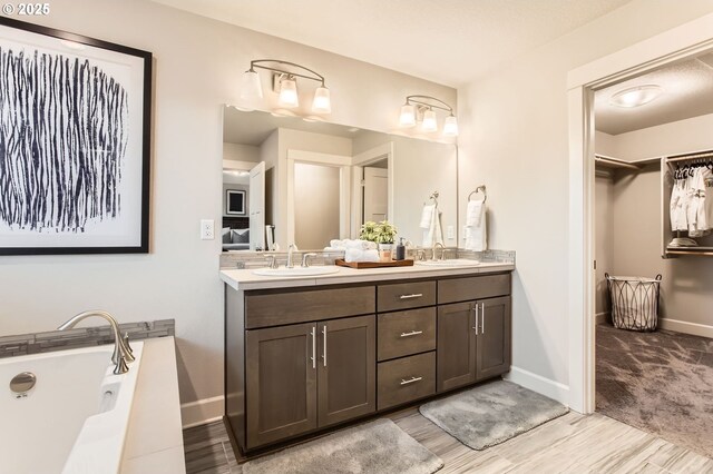 4747 S 17th Dr, Ridgefield, WA 98642 - full bath featuring double vanity, baseboards, a sink, and wood finished floors