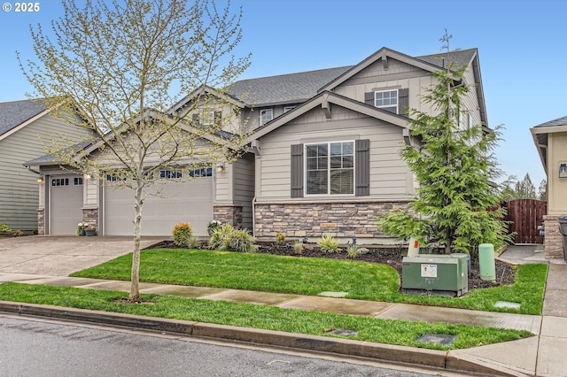 4747 S 17th Dr, Ridgefield, WA 98642 - craftsman house with driveway, stone siding, an attached garage, a front lawn, and fence