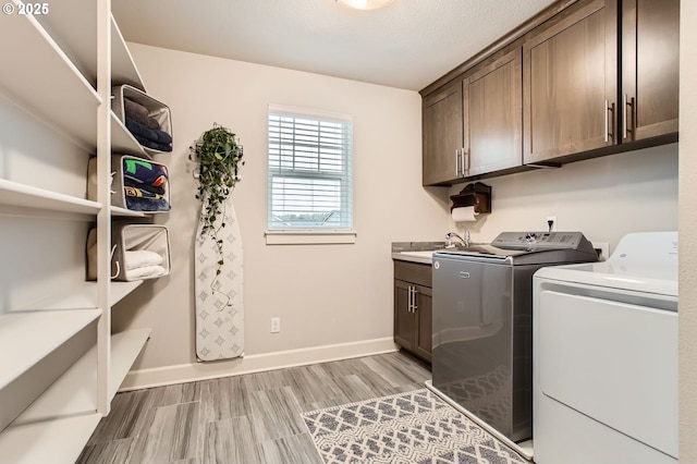 4747 S 17th Dr, Ridgefield, WA 98642 - laundry room featuring washing machine and dryer, baseboards, and cabinet space