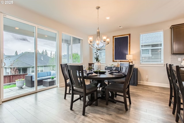 4747 S 17th Dr, Ridgefield, WA 98642 - dining room with baseboards, recessed lighting, a chandelier, and wood finished floors