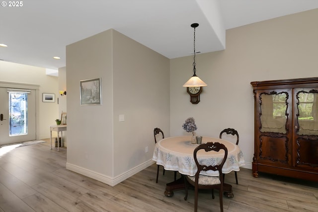 dining area with recessed lighting, baseboards, and light wood finished floors