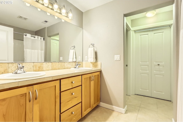 bathroom with tile patterned flooring, double vanity, baseboards, and a shower with shower curtain