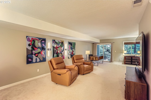 living room with carpet flooring, baseboards, and a textured ceiling