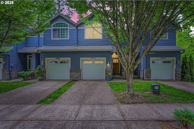 9480 SW 153rd Ave, Beaverton, OR 97007 - view of front facade featuring a garage, concrete driveway, stone siding, and a shingled roof