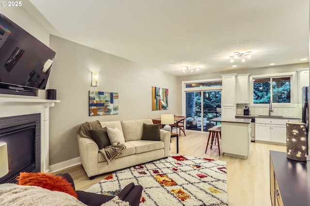9480 SW 153rd Ave, Beaverton, OR 97007 - living room with light wood finished floors and a glass covered fireplace