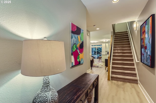 9480 SW 153rd Ave, Beaverton, OR 97007 - hallway featuring wood finished floors, stairs, recessed lighting, and baseboards