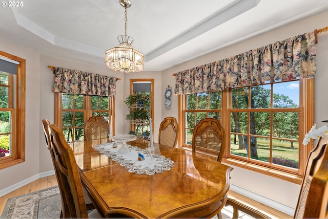 7654 N Bank Rd, Roseburg, OR 97470 - dining room with light wood finished floors, a chandelier, a tray ceiling, and baseboards