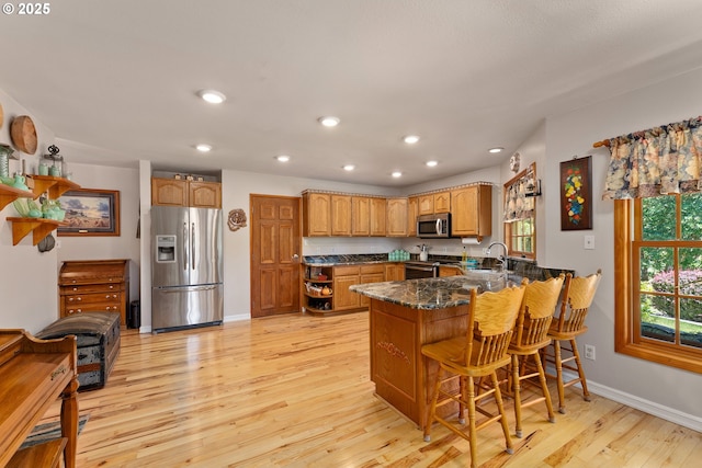 7654 N Bank Rd, Roseburg, OR 97470 - kitchen with stainless steel appliances, a peninsula, recessed lighting, light wood-style floors, and baseboards