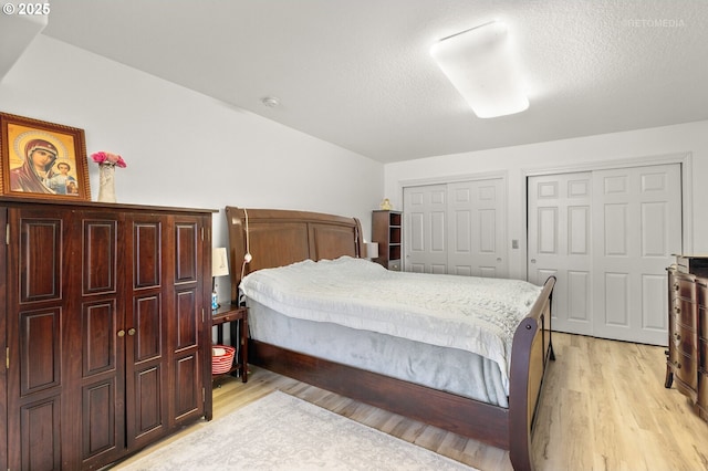 2136 N Thorne St, Newberg, OR 97132 - bedroom with light wood-style flooring, multiple closets, and a textured ceiling