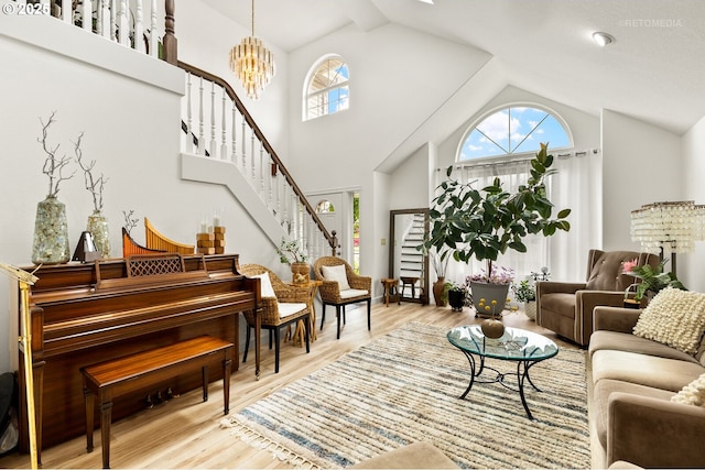 2136 N Thorne St, Newberg, OR 97132 - living room featuring stairs, high vaulted ceiling, wood finished floors, and a chandelier
