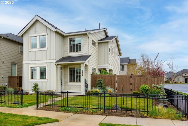 view of front of house with board and batten siding, a fenced front yard, and a front yard