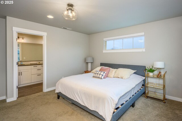 carpeted bedroom with connected bathroom, recessed lighting, and baseboards