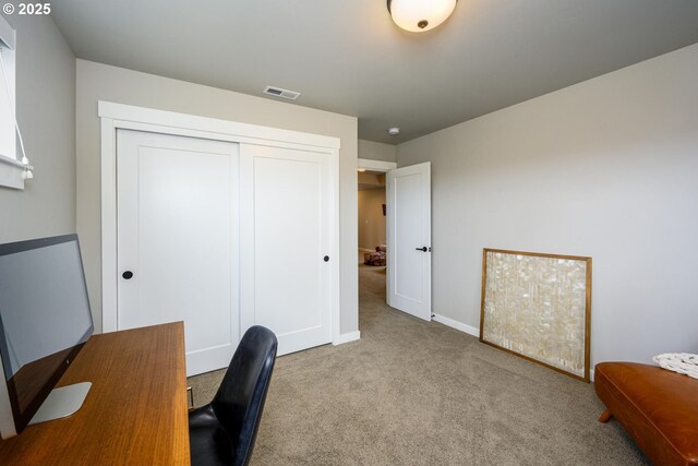 office area featuring carpet floors, baseboards, and visible vents
