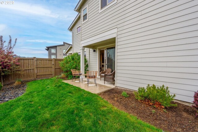 exterior space featuring fence, an outdoor hangout area, a lawn, and a patio area