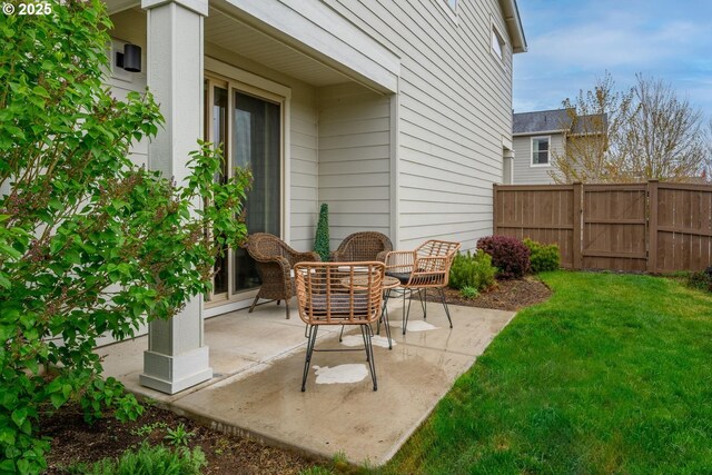 view of patio / terrace featuring fence and a gate