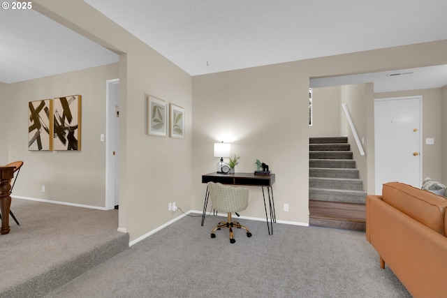 carpeted home office with baseboards