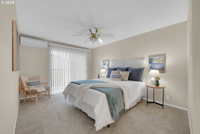 bedroom featuring ceiling fan, a wall unit AC, baseboards, and light colored carpet