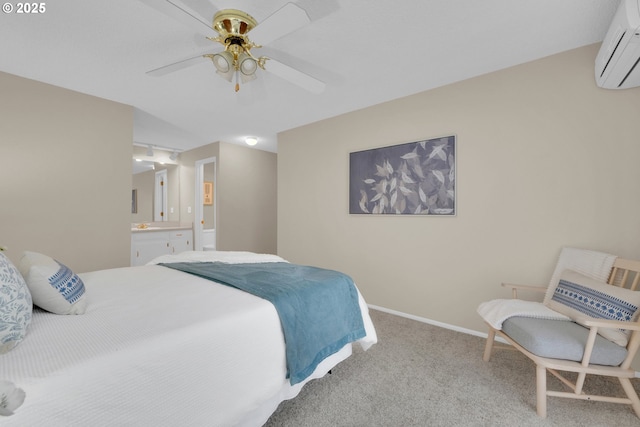 bedroom featuring baseboards, ensuite bath, ceiling fan, a wall mounted air conditioner, and carpet