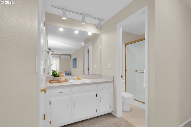 bathroom featuring a stall shower, a wall unit AC, vanity, and toilet