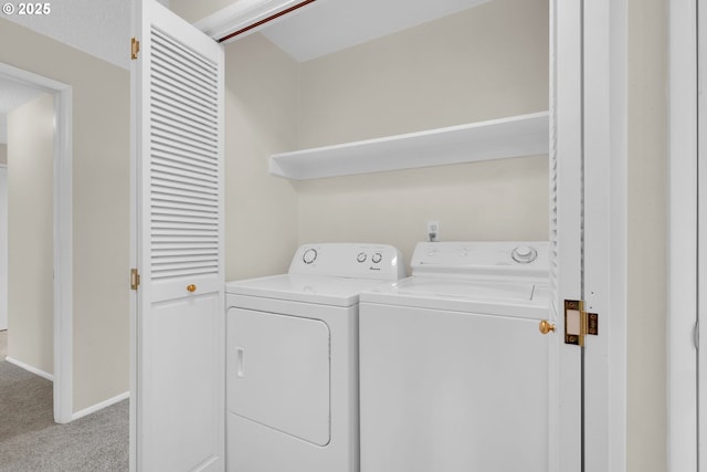 laundry area with laundry area, washer and clothes dryer, carpet flooring, and baseboards