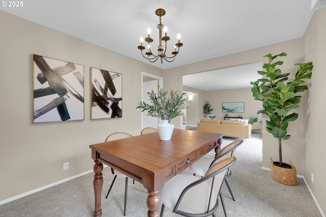 dining area with carpet floors, baseboards, a chandelier, and a textured ceiling