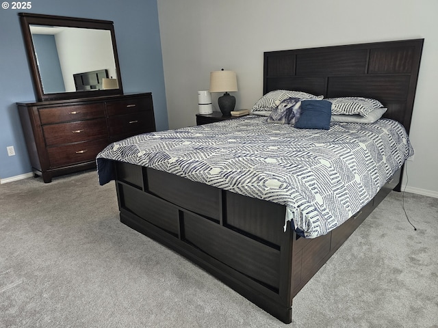 bedroom featuring light carpet and baseboards