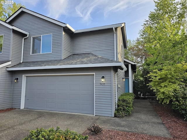 view of property exterior with aphalt driveway and a garage