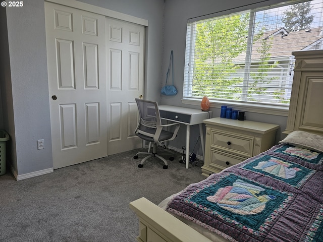 carpeted bedroom with baseboards and a closet