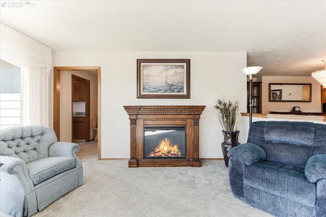 129 Cedar Falls Dr, Kelso, WA 98626 - carpeted living room featuring a glass covered fireplace, a notable chandelier, and baseboards