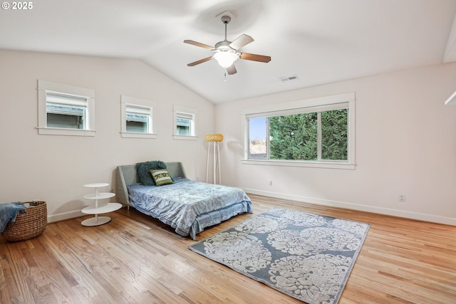 bedroom with ceiling fan, vaulted ceiling, and light wood-type flooring