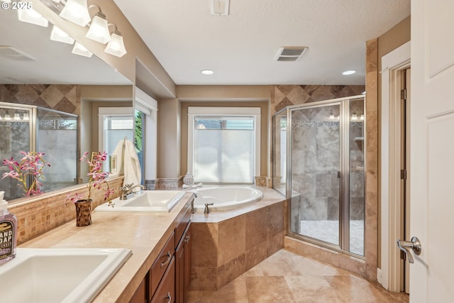 bathroom with vanity, separate shower and tub, and a textured ceiling