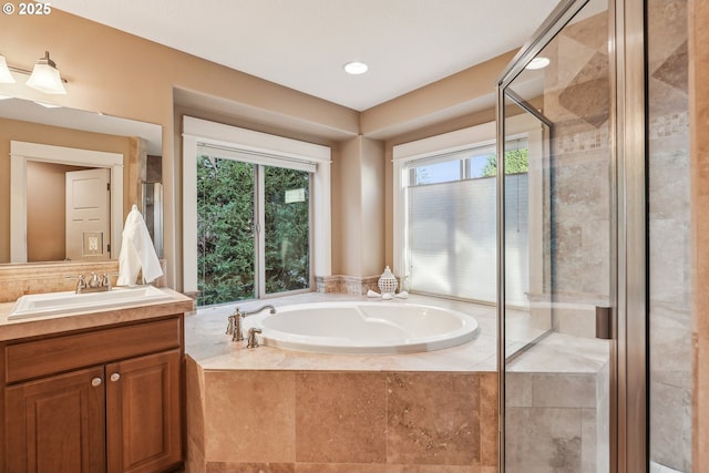 bathroom featuring vanity and separate shower and tub