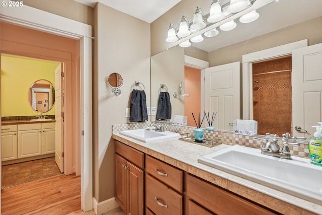 bathroom featuring tasteful backsplash, vanity, and hardwood / wood-style floors