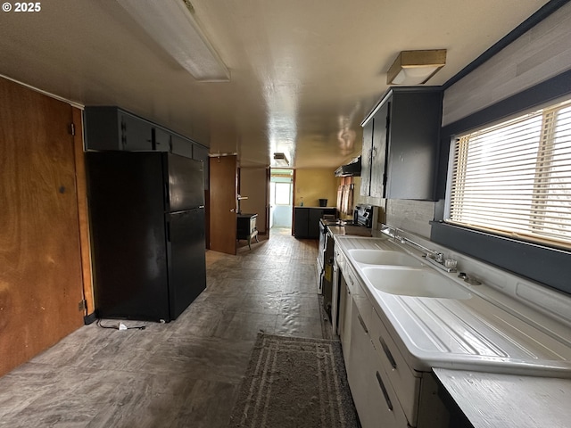103 B Ave, Seneca, OR 97873 - kitchen featuring freestanding refrigerator, range, under cabinet range hood, and light countertops
