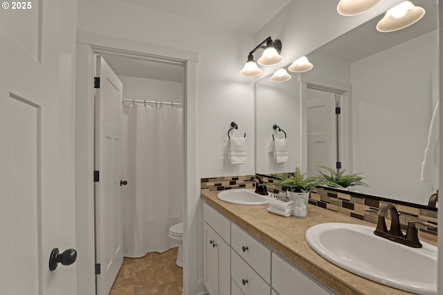 5316 SE Lone Oak St, Hillsboro, OR 97123 - bathroom featuring a sink, tasteful backsplash, double vanity, and toilet