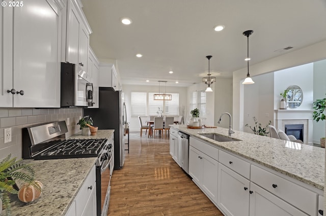 5316 SE Lone Oak St, Hillsboro, OR 97123 - kitchen with a sink, dark wood-style flooring, appliances with stainless steel finishes, white cabinetry, and backsplash