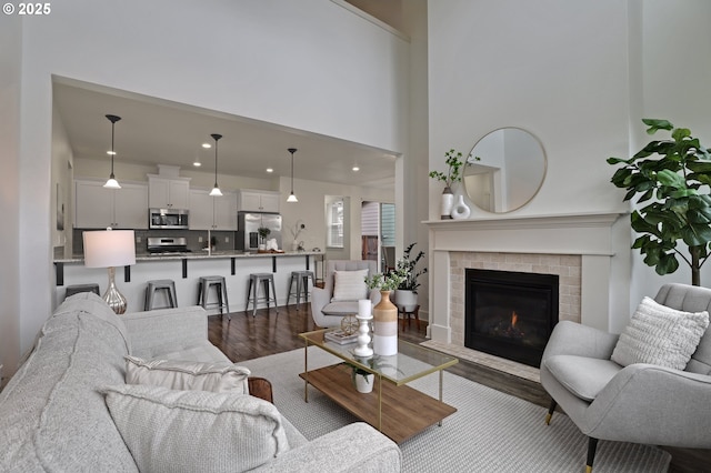 5316 SE Lone Oak St, Hillsboro, OR 97123 - living room with a fireplace, a towering ceiling, and dark wood-style floors