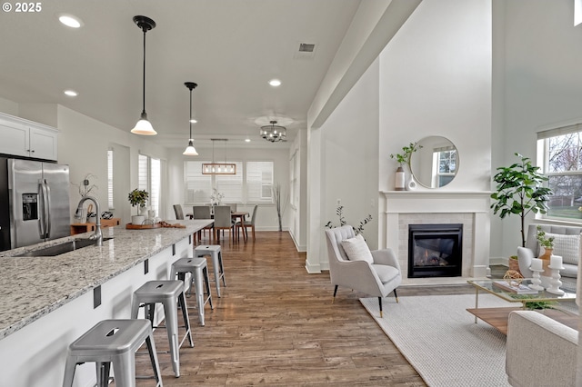 5316 SE Lone Oak St, Hillsboro, OR 97123 - living area featuring light wood-style flooring, visible vents, recessed lighting, a tile fireplace, and baseboards