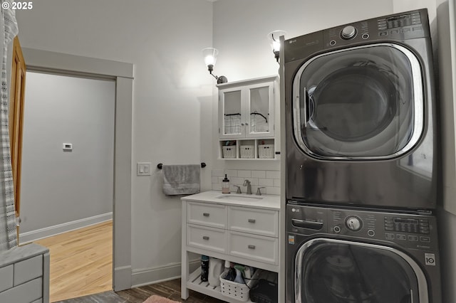 2176 NW Everett St Unit 1, Portland, OR 97210 - laundry area with stacked washer / drying machine and wood finished floors