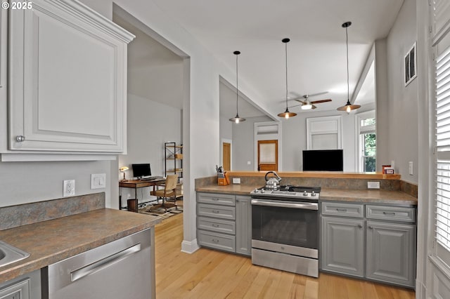2176 NW Everett St Unit 1, Portland, OR 97210 - kitchen featuring appliances with stainless steel finishes, gray cabinetry, light wood finished floors, and ceiling fan