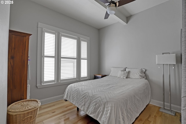 2176 NW Everett St Unit 1, Portland, OR 97210 - bedroom featuring light wood-style flooring, beamed ceiling, and a ceiling fan