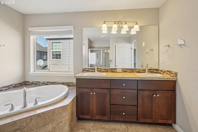 bathroom featuring vanity, tasteful backsplash, and separate shower and tub