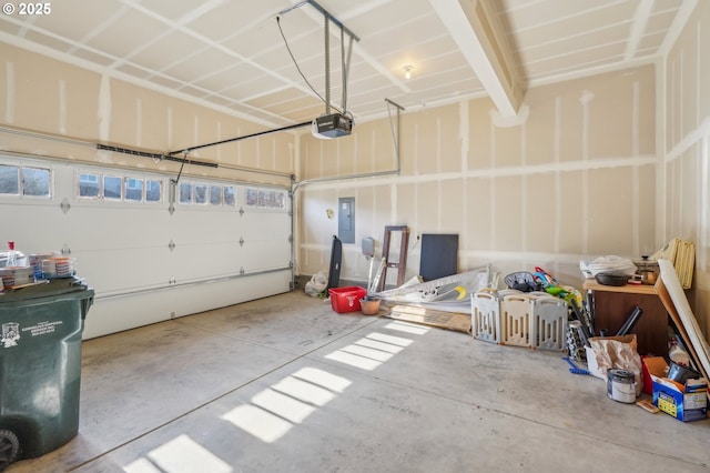 garage with a garage door opener and electric panel