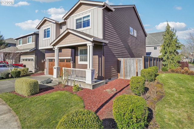 view of front of property featuring a porch, a garage, and a front yard