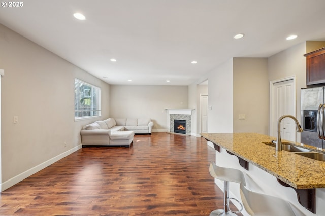 living room featuring sink and dark hardwood / wood-style flooring