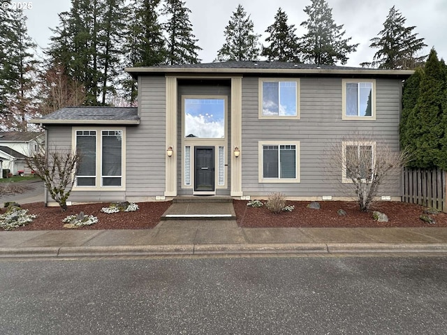 view of front of house featuring fence and crawl space