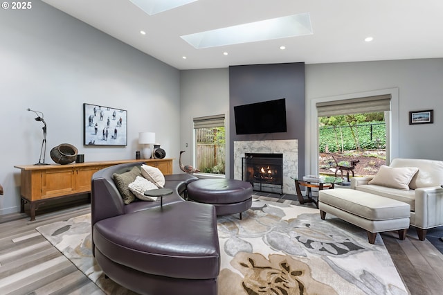 240 Greenridge Dr, Lake Oswego, OR 97035 - living room with a skylight, healthy amount of natural light, light wood-style flooring, a fireplace, and recessed lighting